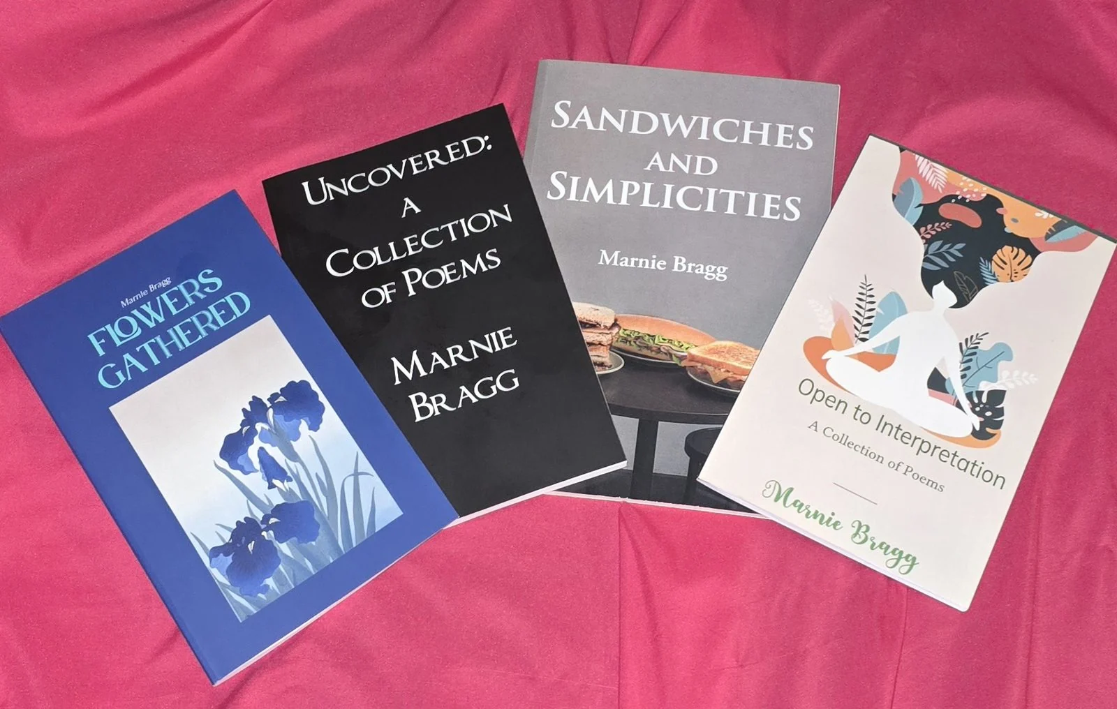 The four poetry books by Marnie Bragg, stacked together